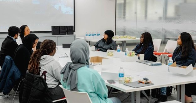 students sitting around a conference room table