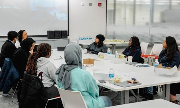 group of people sitting around large table talking