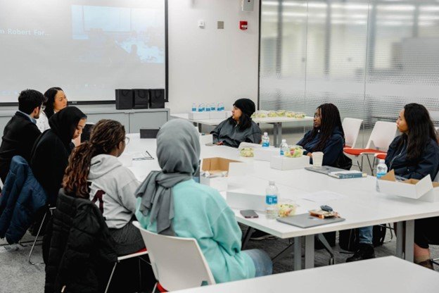 group of people sitting around large table talking