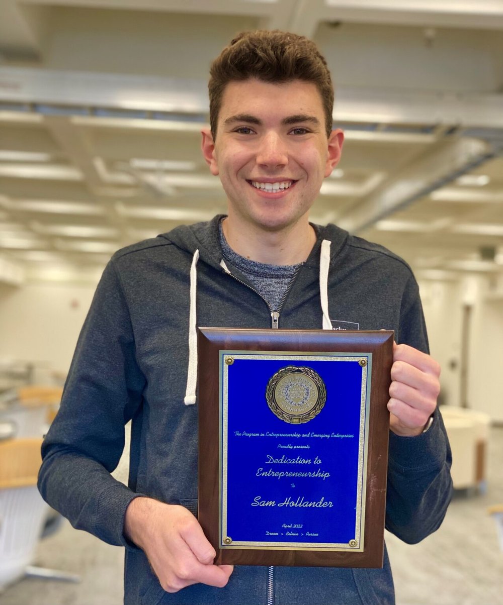 young man holding plaque