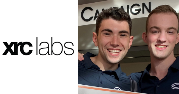 Sam Hollander and James LePage smile for a photo, placed next XRC Labs logo