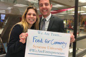 two people holding a sign