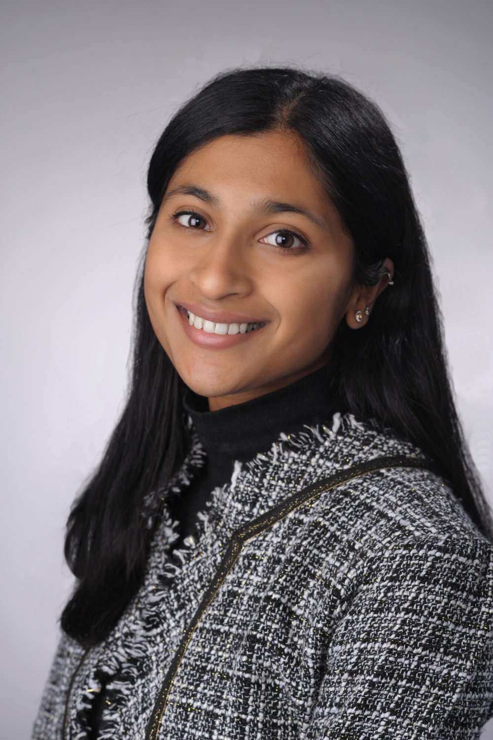 Sandhy Iyer poses for a professional headshot