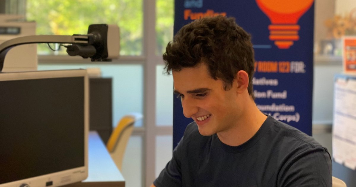 student working on computer in library