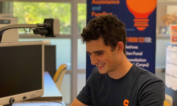 student working on computer in library