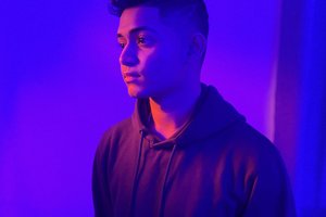 student against purple lighting