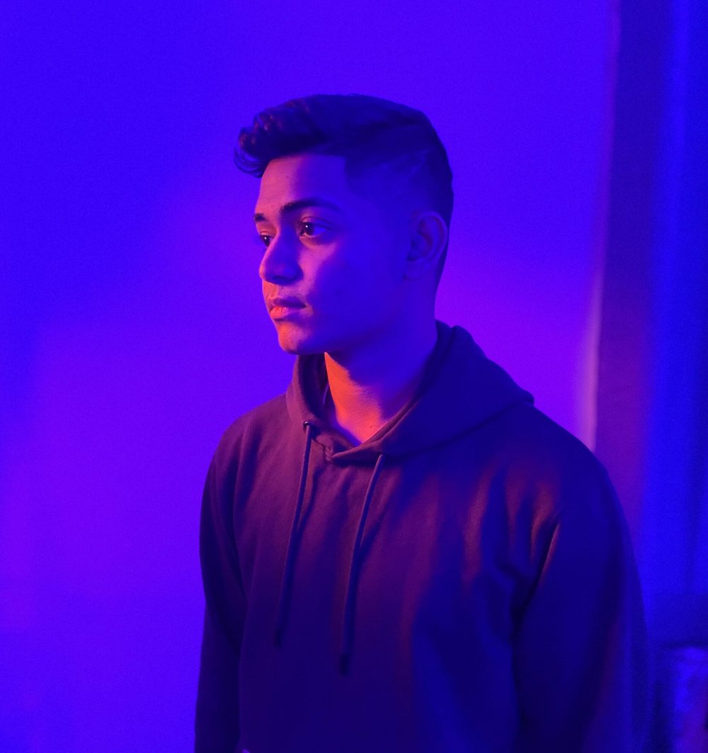 student against purple lighting
