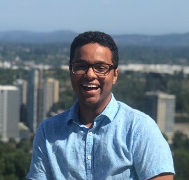 person smiling with city in background