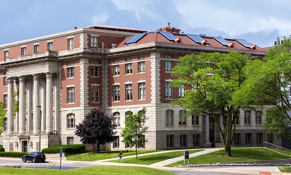 Slocum Hall surrounded by green trees and grass