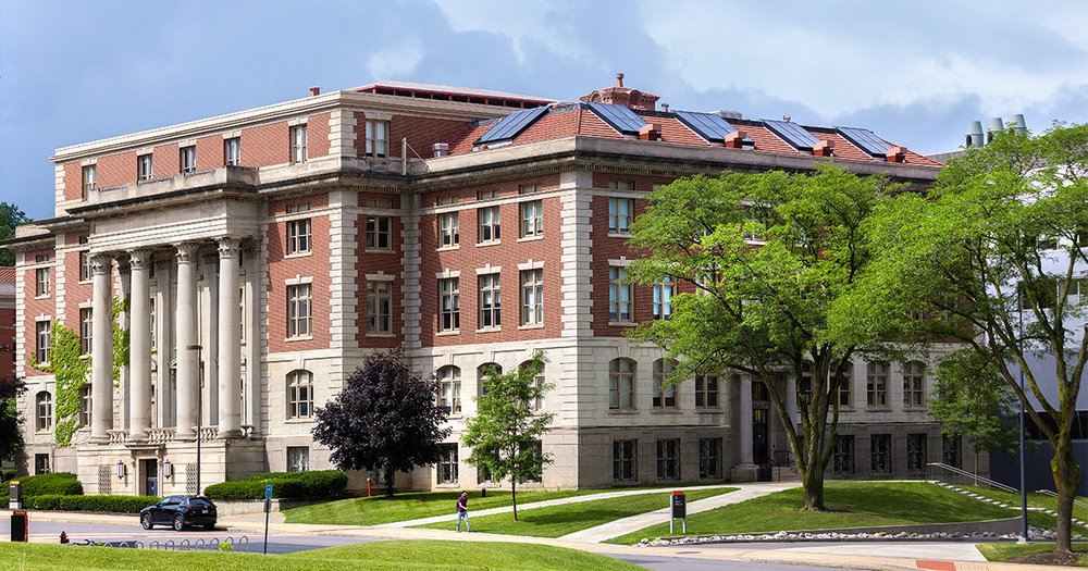 Slocum Hall surrounded by green trees and grass