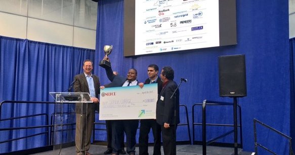 SparkCharge team holding trophy on stage