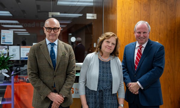 three people posing for camera