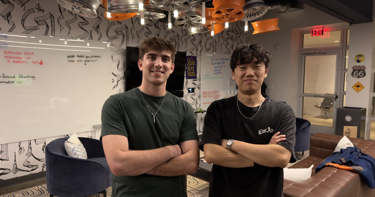 Two people posing with arms crossed.