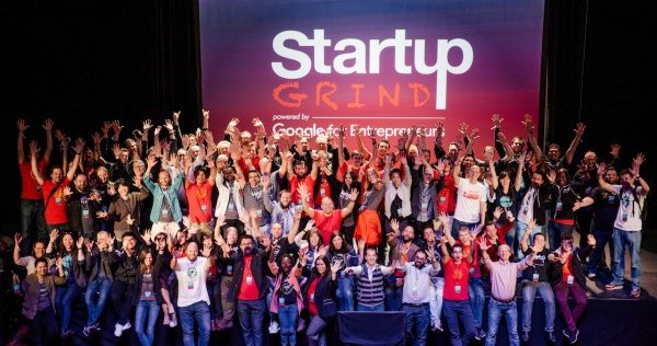 crowd of people in front of sign that says Startup