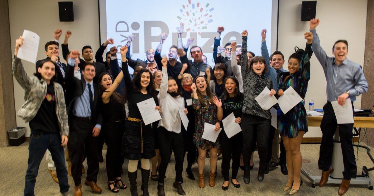 student raise their hands for a photo