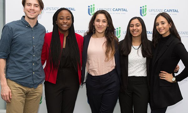5 students in front of Upstate Capital backdrop