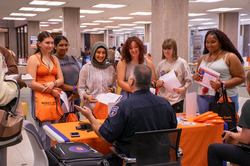 students stand in front of table in Bird Library listening to DPS Officer Wazen