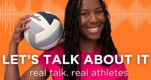 black woman holding volleyball