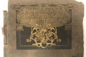 Gold lettering on tattered cover with words Syracuse Ornamental Company