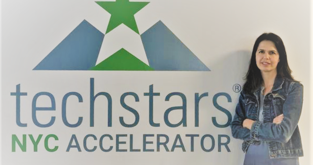 Woman in front of Techstars sign