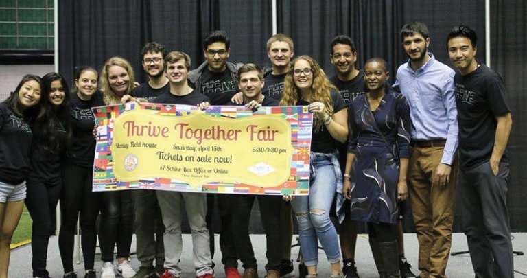 people take a group picture at Thrive Together Cultural Fair