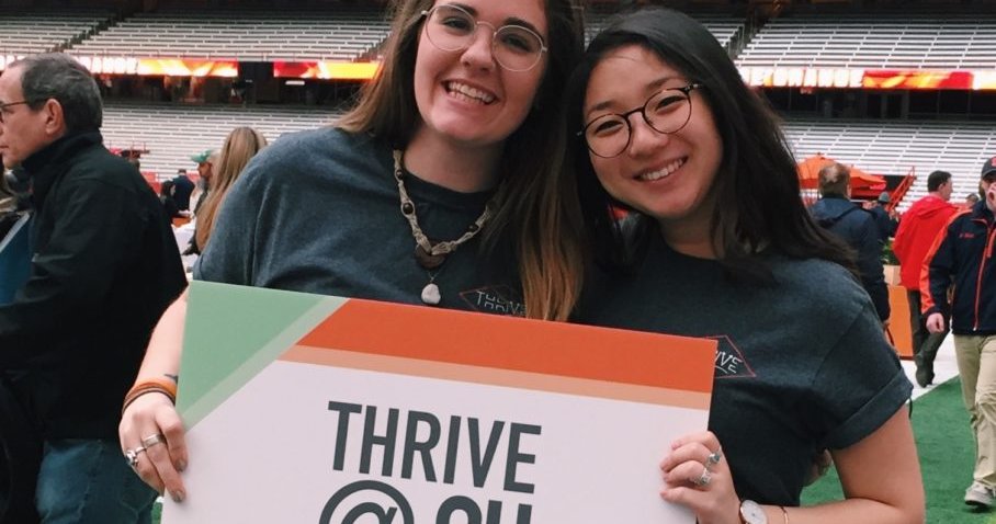 Audrey Miller and Amanda Chou holding thrive @SU banner