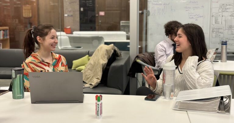 Two female students talking at Blackstone LaunchPad office
