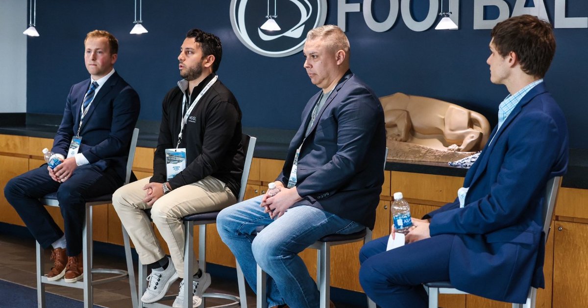 four men in professional attire speak at NIL Agencies Panel
