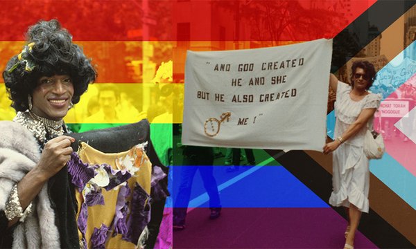 pride flag behind people in LGBTQ parade