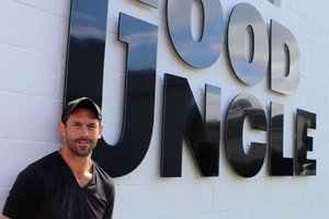 Wiley Cerilli in front of Good Uncle sign