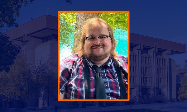 person in square with blue sepia of Bird Library in background