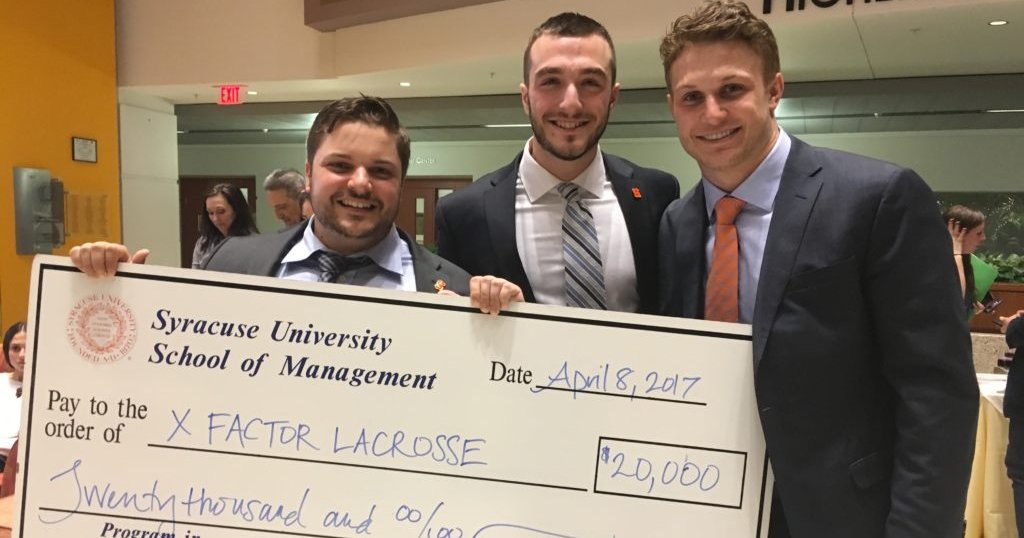 three men holding an oversized check