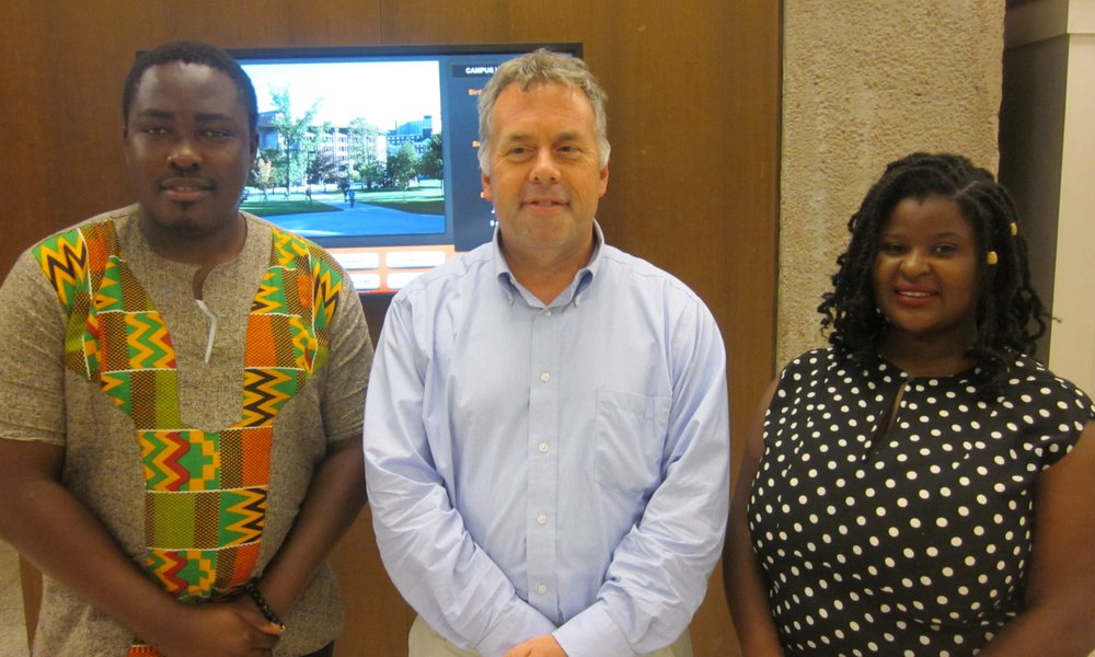 YALI Fellows standing on either side of Michael Pasqualoni, librarian, in the middle