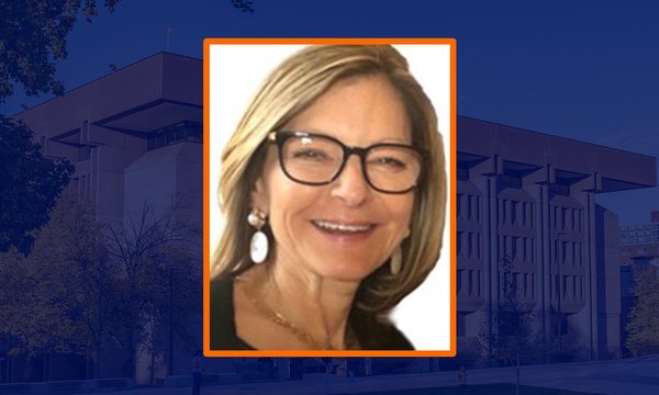 female  headshot with blue sepia image of Bird Library in background