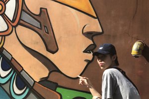 Zero Lin posing by mural