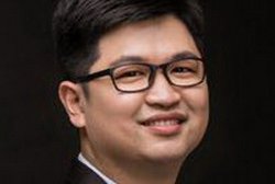 man in suit smiles for a photo