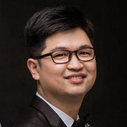 man in suit smiles for a photo