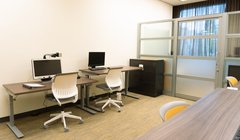 assistive tech room with three computer stations with chairs