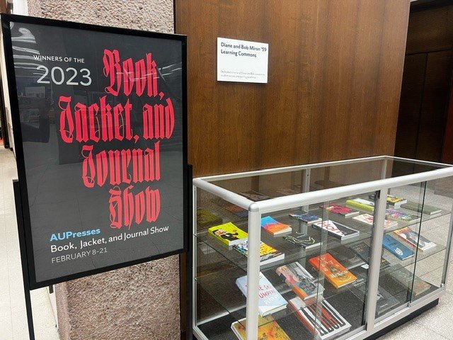 poster saying Book Jacket and Journal Show next to display case