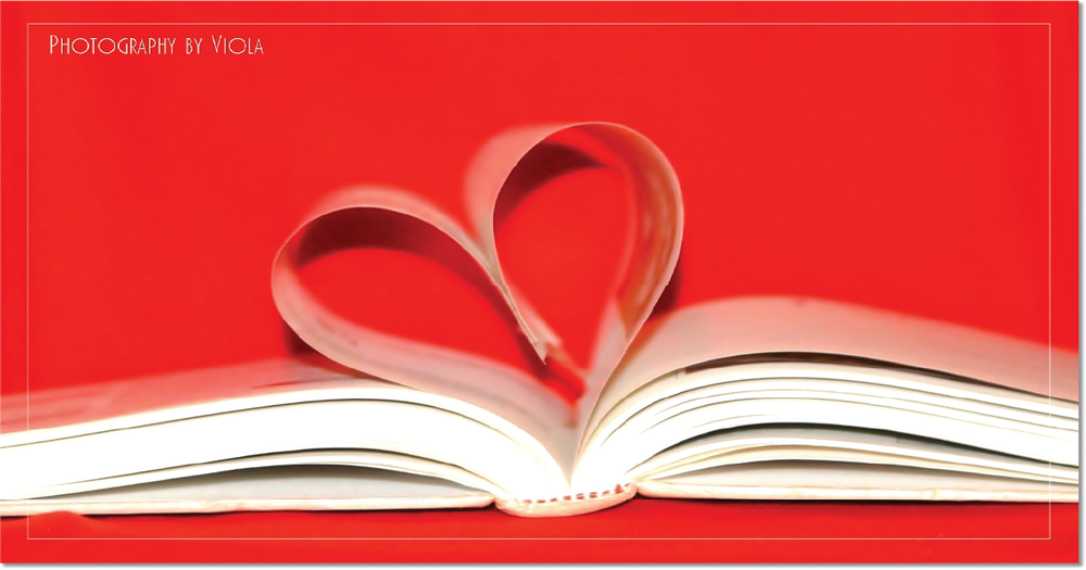 book open with pages making heart with red background