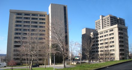 two large multi-story gray buildings situated side by side