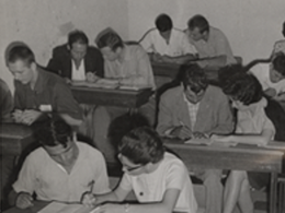 adult students sitting at desks working in pairs