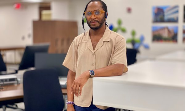Black man leaning against counter