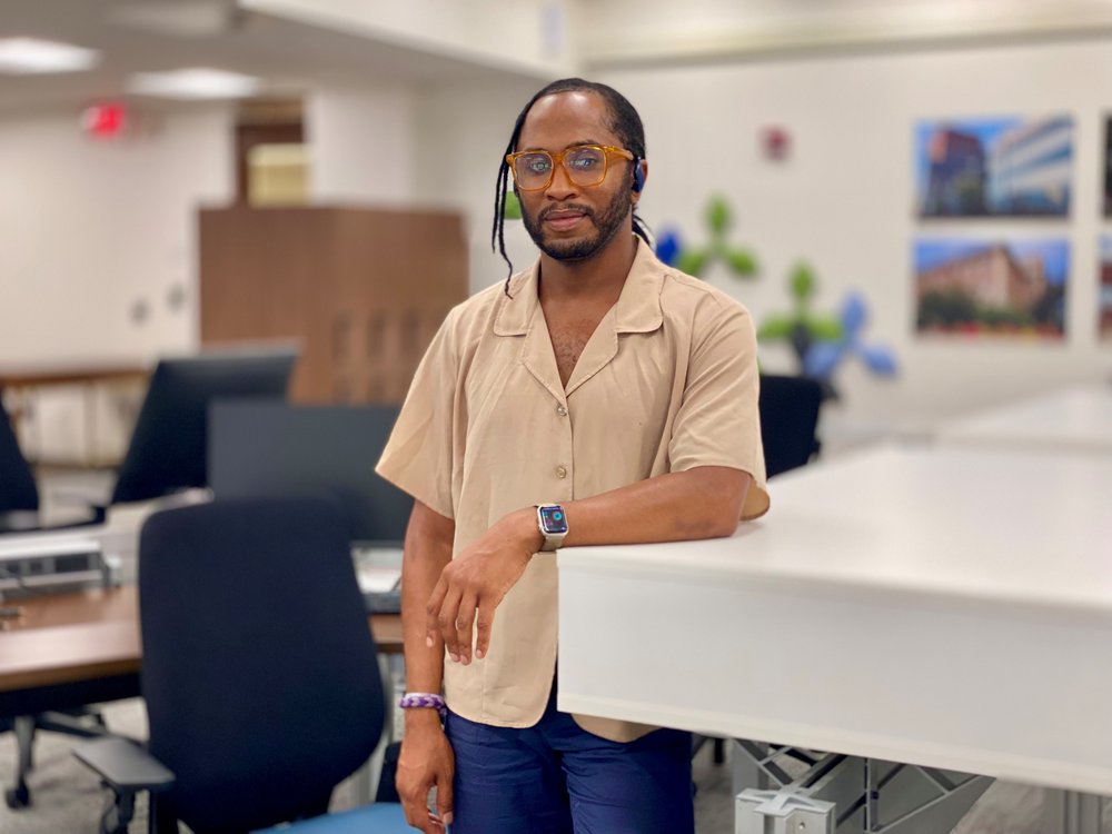 Black man leaning against counter