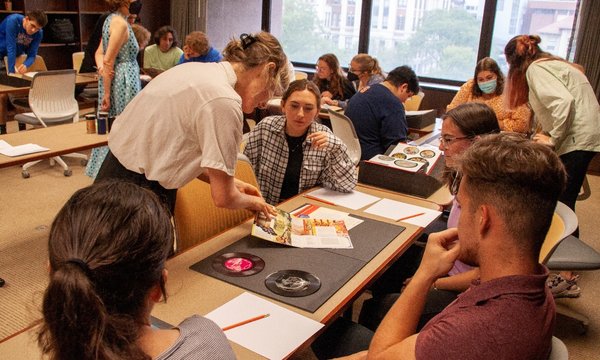 person showing materials from special collections to students