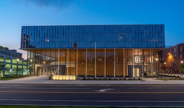 glass building with row of flags in front