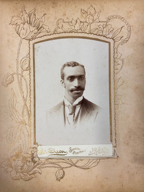detroit album; Black man wearing jacket and tie with mustache