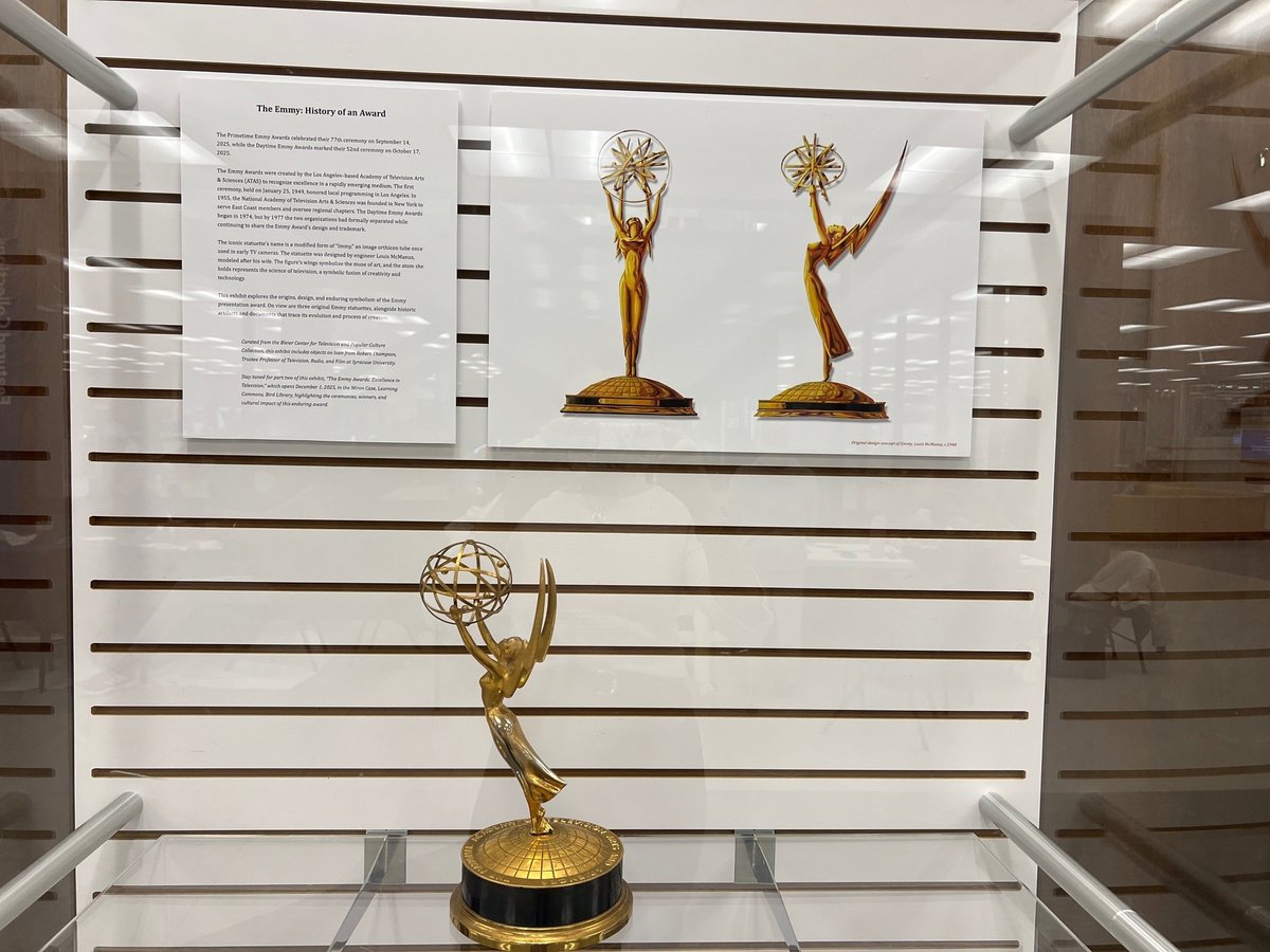 glass display with emmy's and description