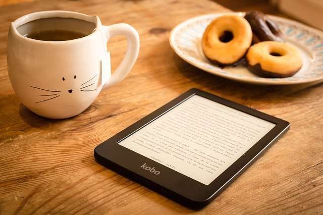 donut and coffee next to electronic pad