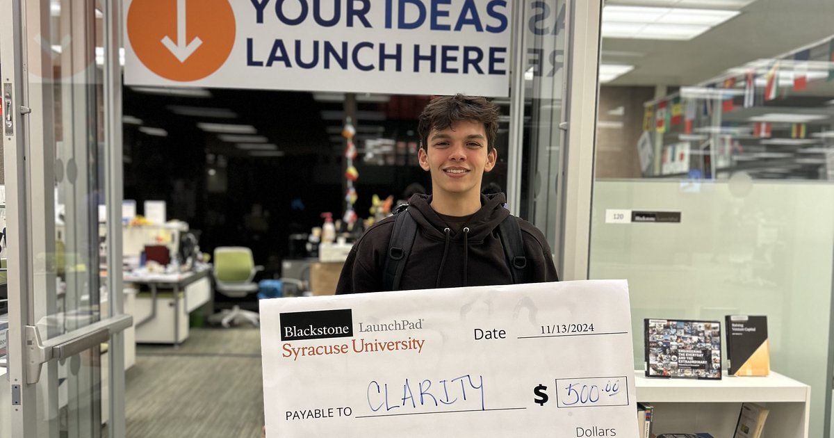 student holding large check